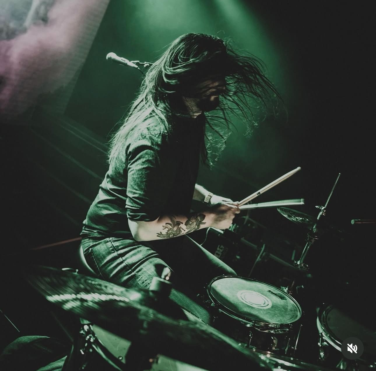 Danny drumming live with hair mid-swing